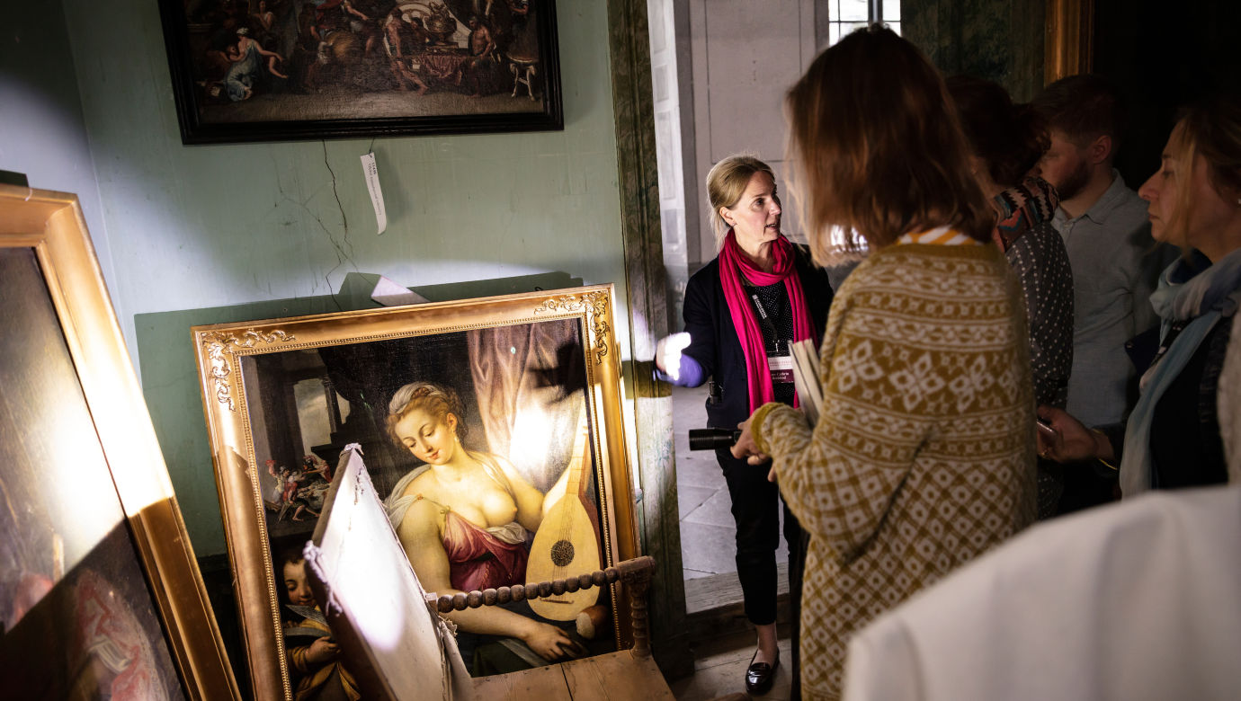 A curator shows art in the castle.