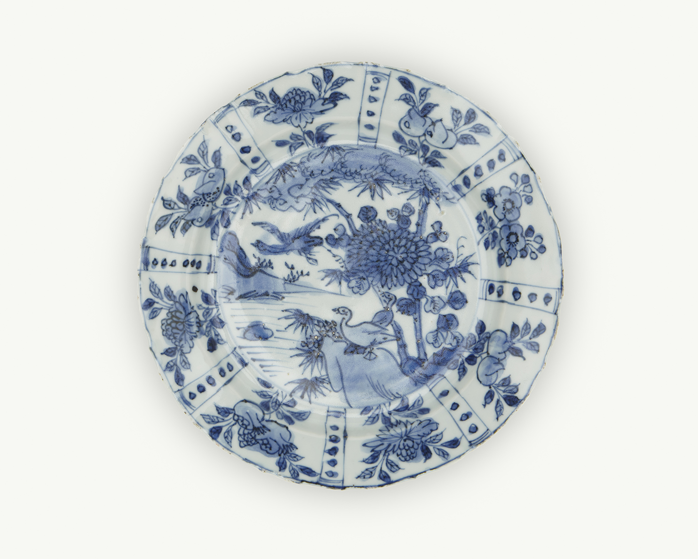 A white plate decorated with blue flowers and birds.