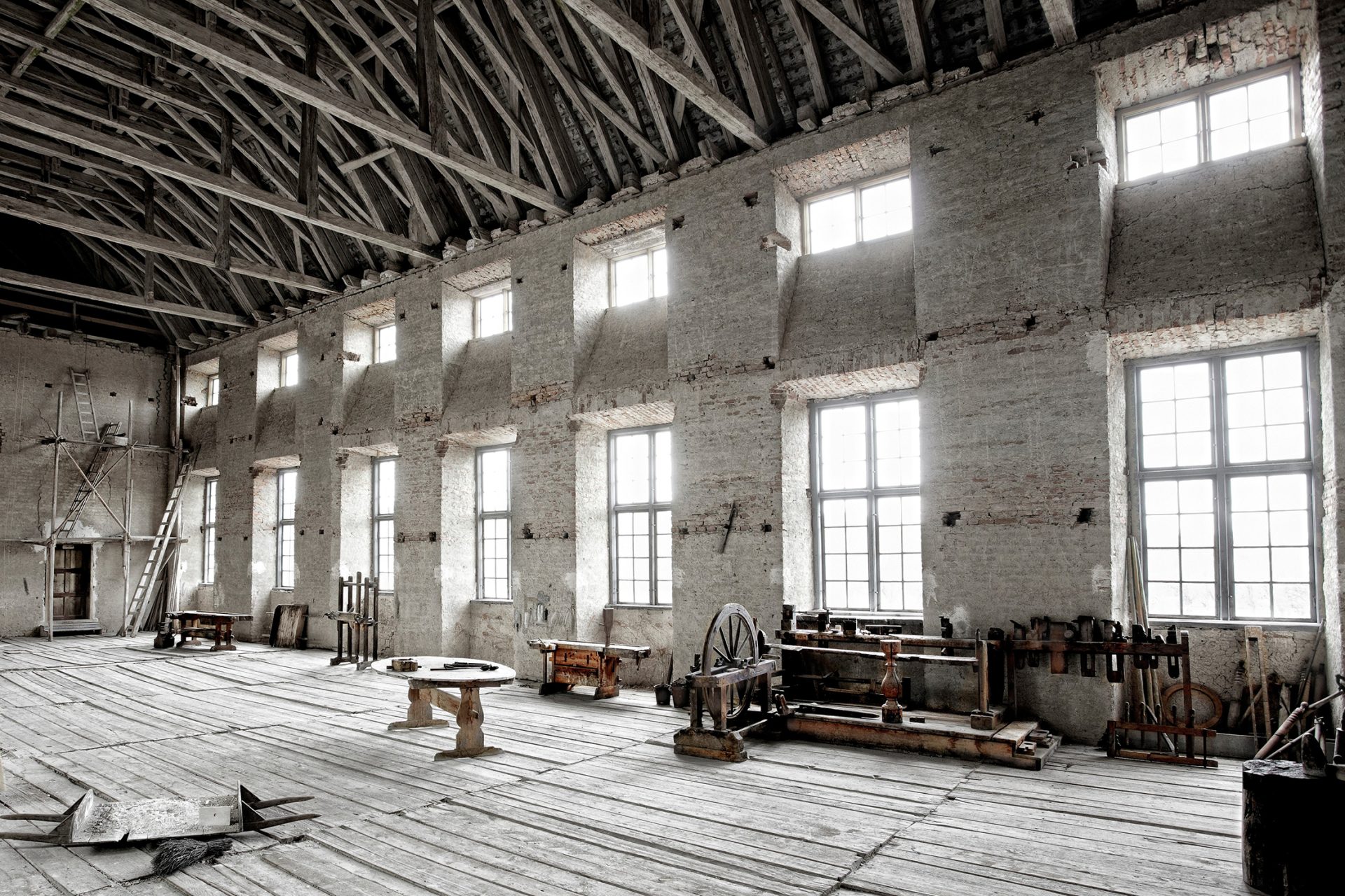 The Unfinished Hall with its bare walls and wooden floor.