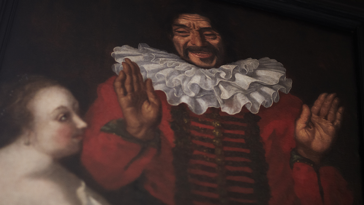 Detalj av en målning som föreställer en person med stor vit krage.
