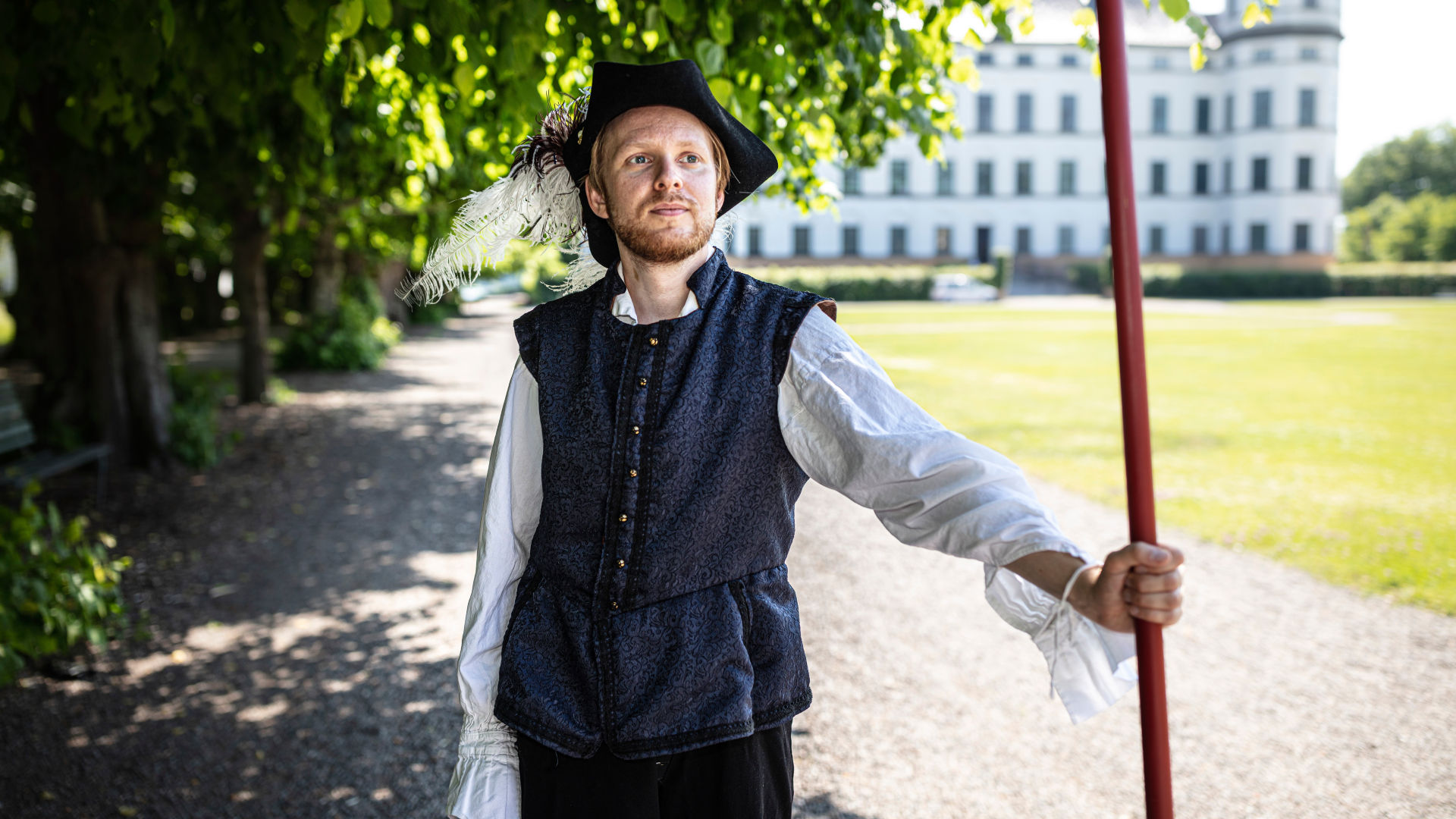 One of the guides wearing period costume standing in front of the castle..