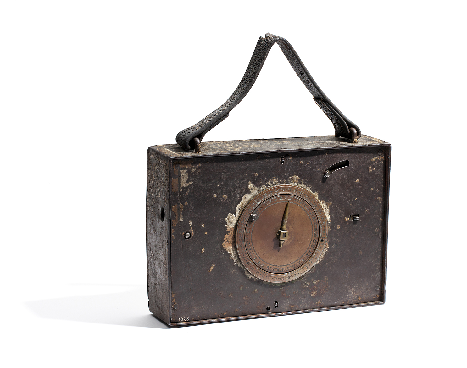 A metal box with a copper clock-face. On the top a leather handle.