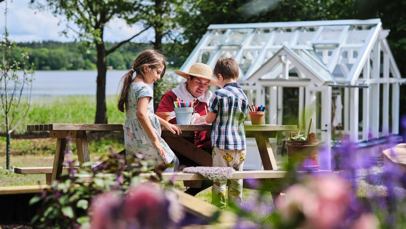 Två barn tillsammans med en vuxen vid Parkleken Paradiset vid Skoklosters slott