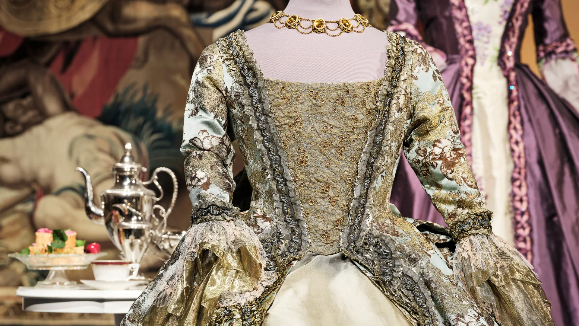 Glittery metallic dress with a tea serving in the background