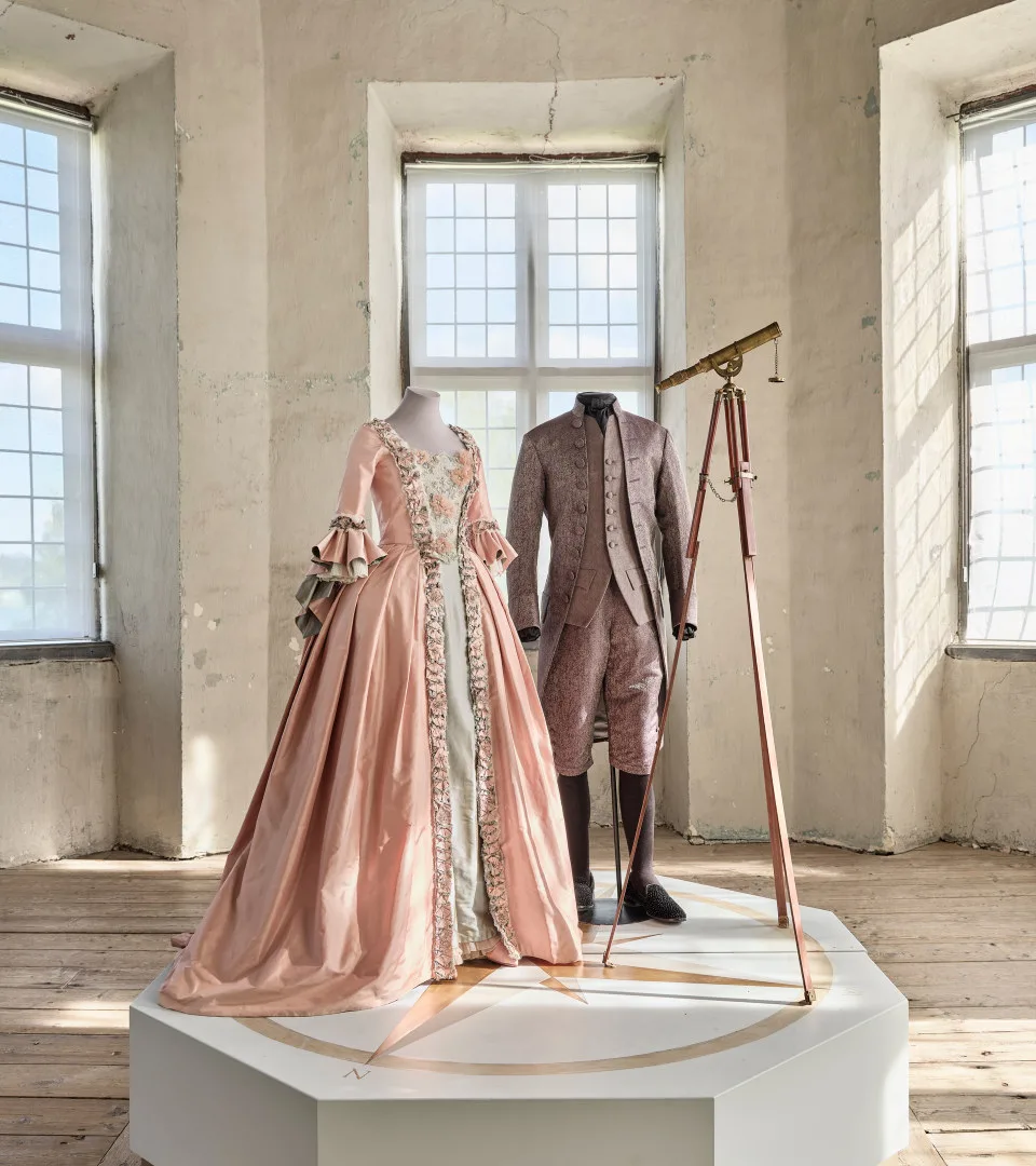 Dress and suit in an onservatory with telescope